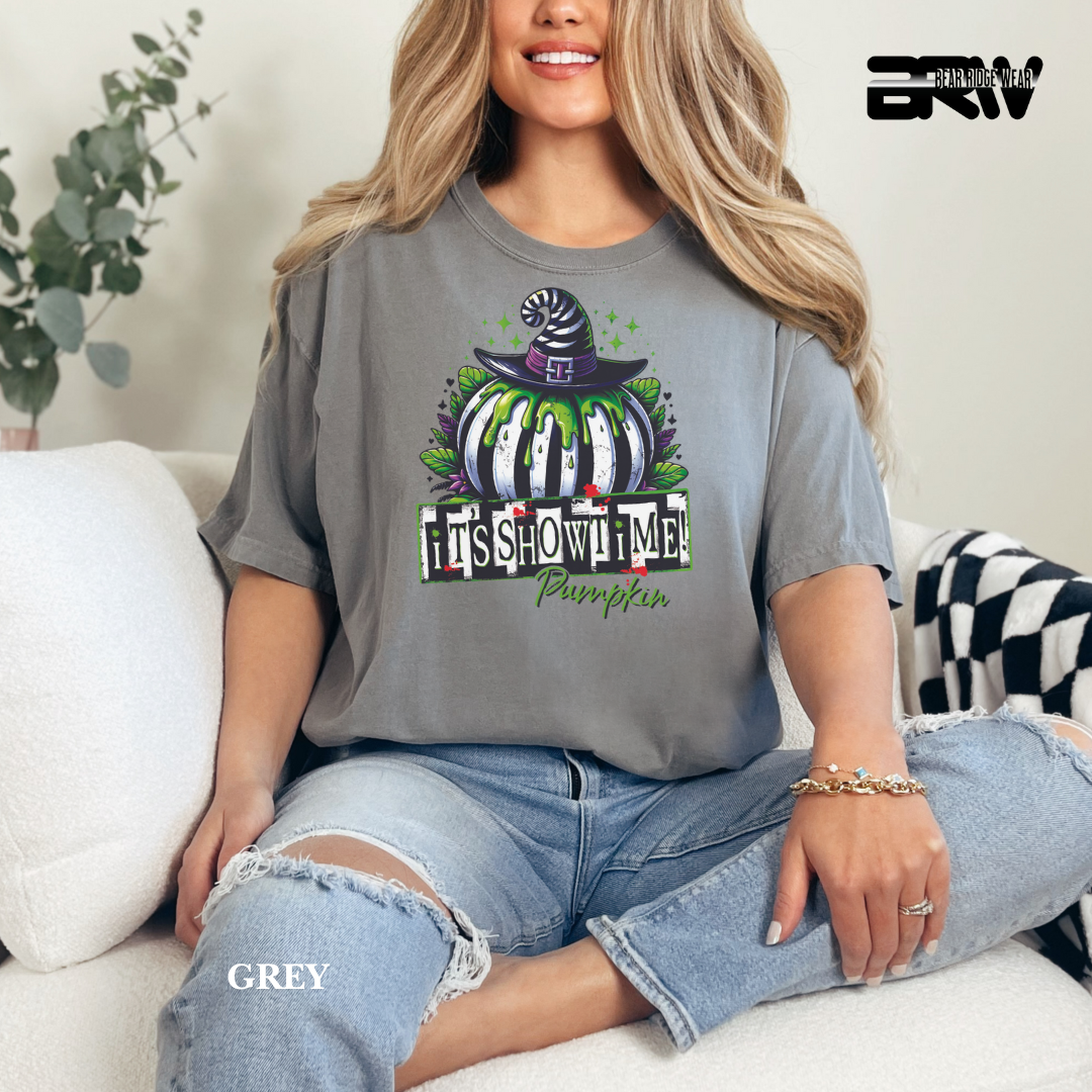 Woman wearing a gray t-shirt with a Halloween-themed design, sitting on a couch.