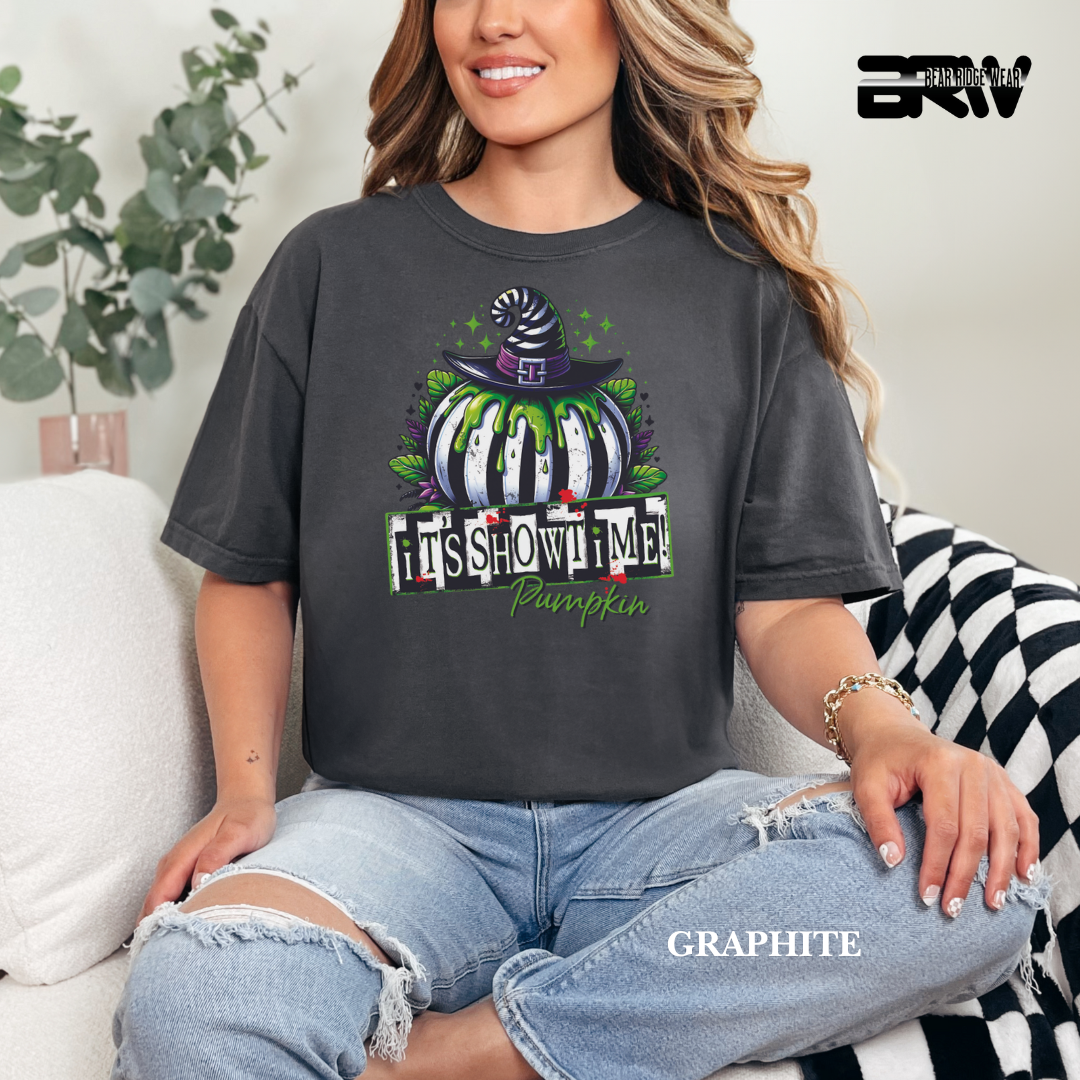 Person wearing a dark gray t-shirt with a Halloween-themed design, sitting on a couch.