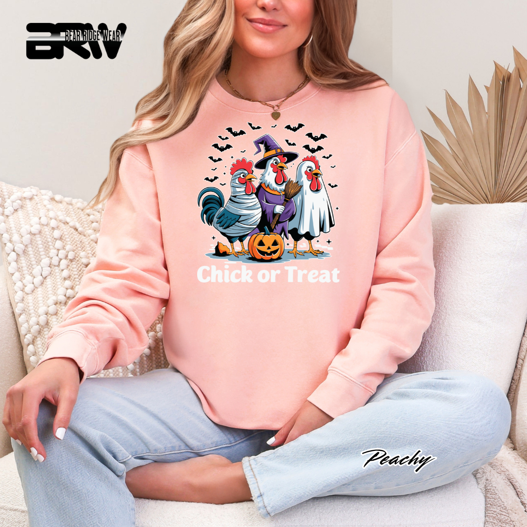 Person wearing a pink sweatshirt with Halloween-themed rooster graphics and 'Chick or Treat' text.