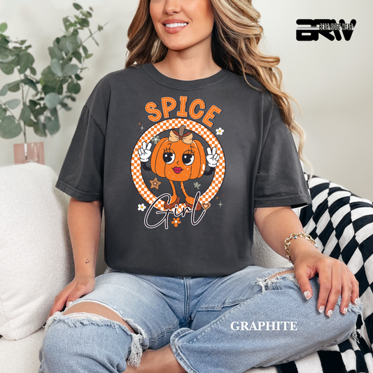Person wearing a dark gray t-shirt with a pumpkin graphic and 'Spice Girl' text, sitting on a couch.