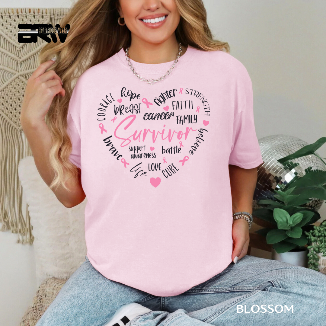 Woman wearing a pink 'Breast Cancer Survivor' t-shirt with motivational phrases.
