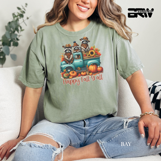 Person wearing a green t-shirt with a fall-themed graphic and text, sitting on a couch.