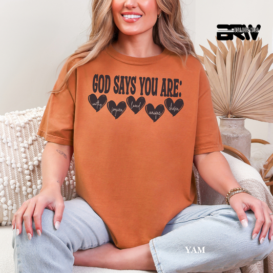 Person wearing a brown t-shirt with text sitting on a couch.