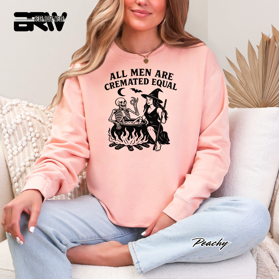 Person wearing a pink sweatshirt with a graphic design and text, sitting on a couch.