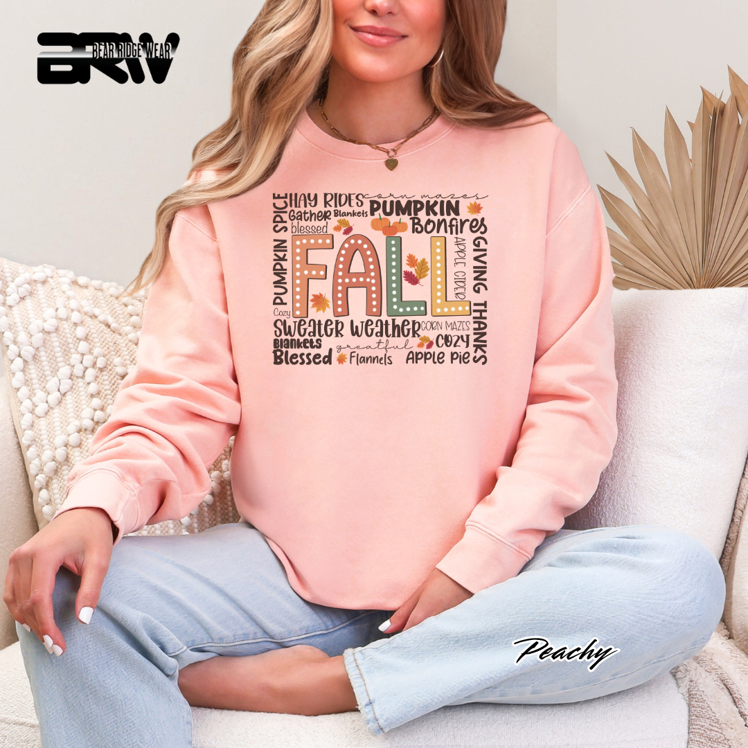 Person wearing a pink sweatshirt with 'Fall' text, sitting on a couch.