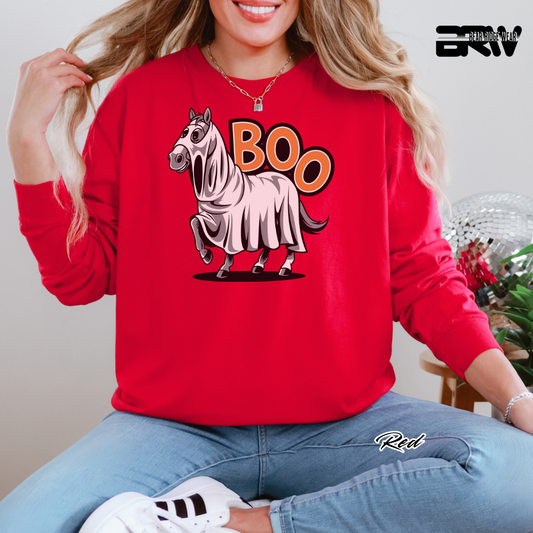 Person wearing a red sweatshirt with a HORSE graphic and 'BOO' text, sitting indoors. PUMPKIN AND FALL LONG SLEEVE TEE